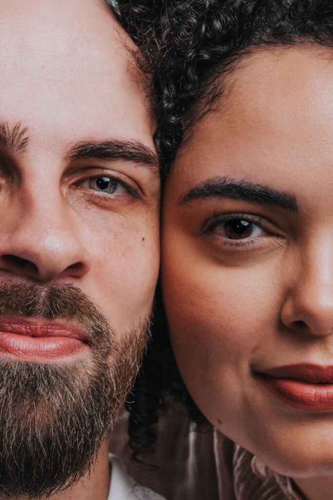 Intimate close-up of a diverse adult couple's faces showcasing unity and love.